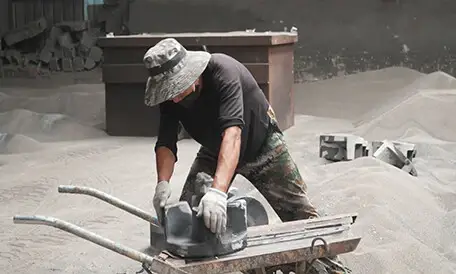 Chenma production worker moving pump part